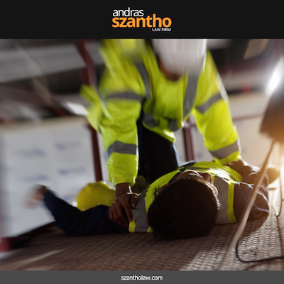 Construction worker helping an injured colleague lying on the ground at an Albuquerque job site
