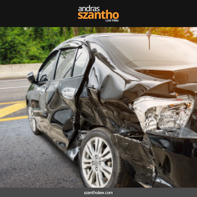 A black car with significant rear-end damage after an Albuquerque car accident