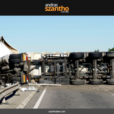 After a highway truck accident in Albuquerque, an overturned truck lies on its side