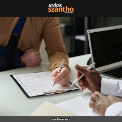 An injury victim with their arm in a sling, signing paperwork related to their accident claim