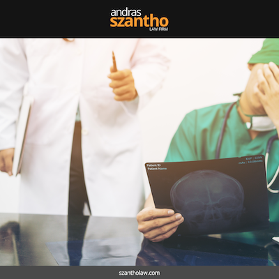 Doctor reviewing an X-ray while another medical professional gestures in a clinical setting